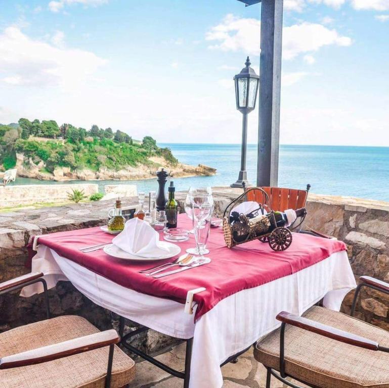Table set for dinner on a stone terrace above the Adriatic at Villa Marinero in Ulcinj
